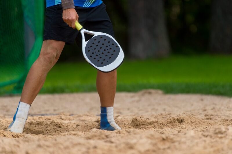 homem segurando raquete para beach tennis