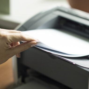Impressora imprimindo uma página no trabalho em home office.